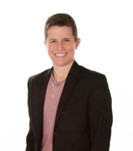 A smiling woman in a black jacket and pink shirt at a Pennsylvania wedding.