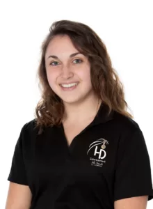A young woman in a black polo shirt smiling at a Gettysburg wedding.