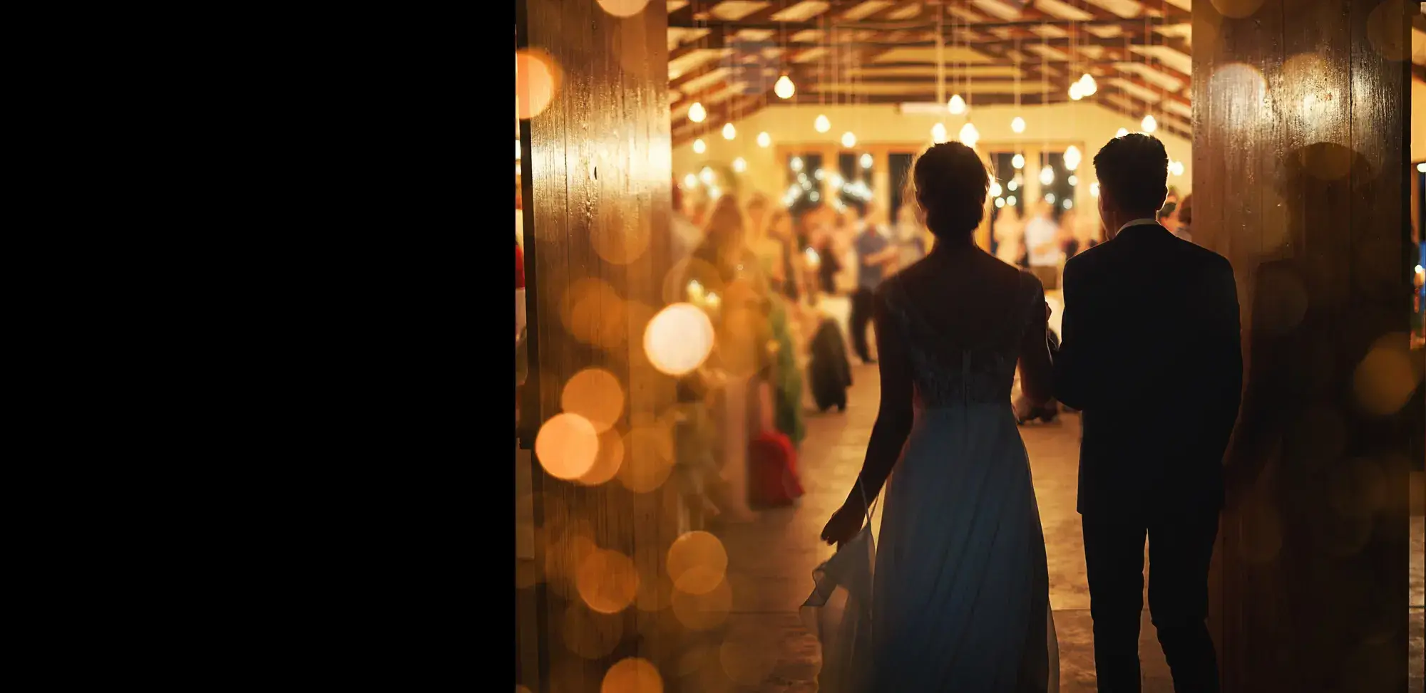 A bride and groom walking through a hallway with lights in the background, captured by experienced Gettysburg DJs.