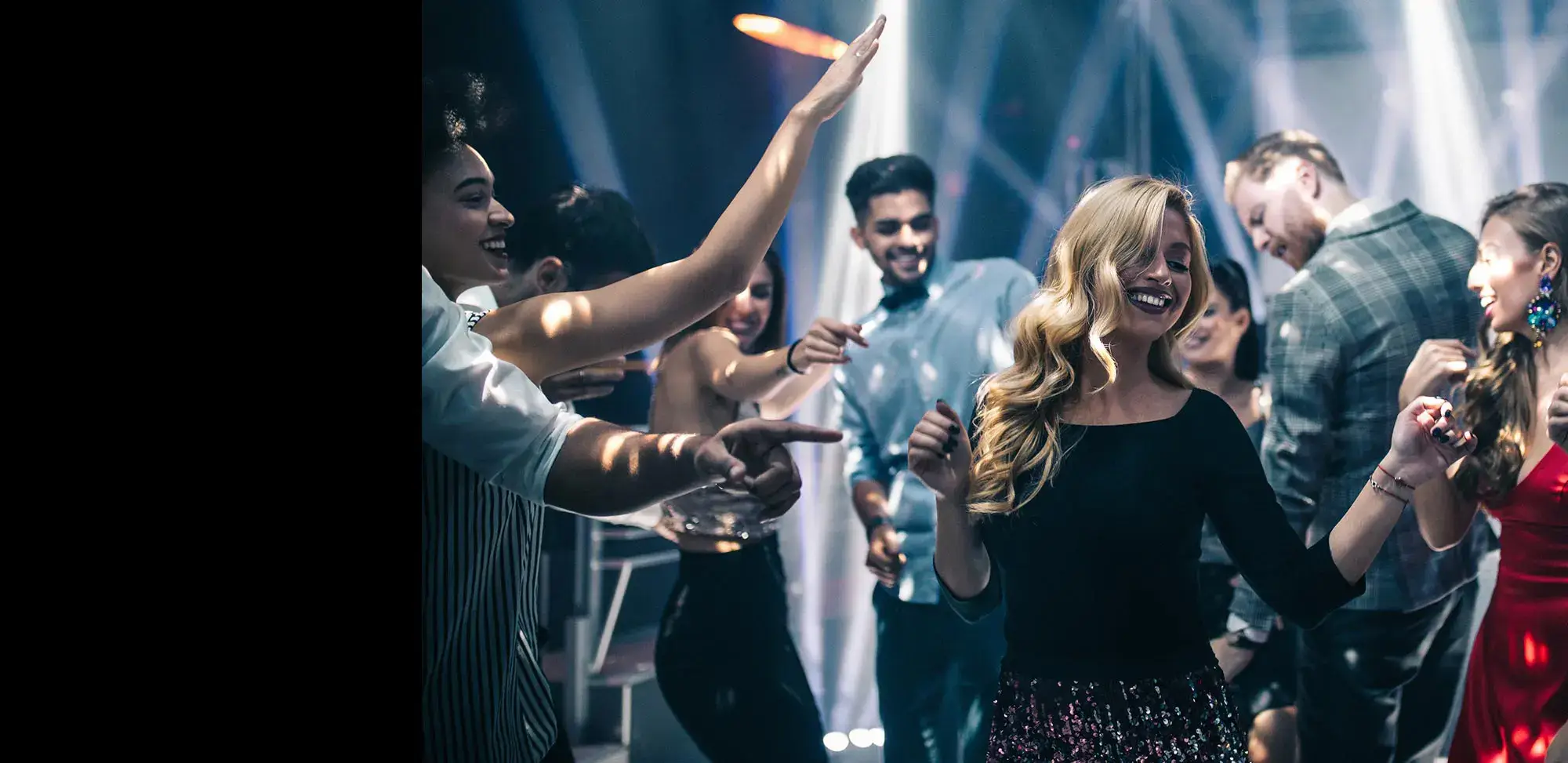 A group of people dancing at a nightclub, accompanied by energetic DJs.