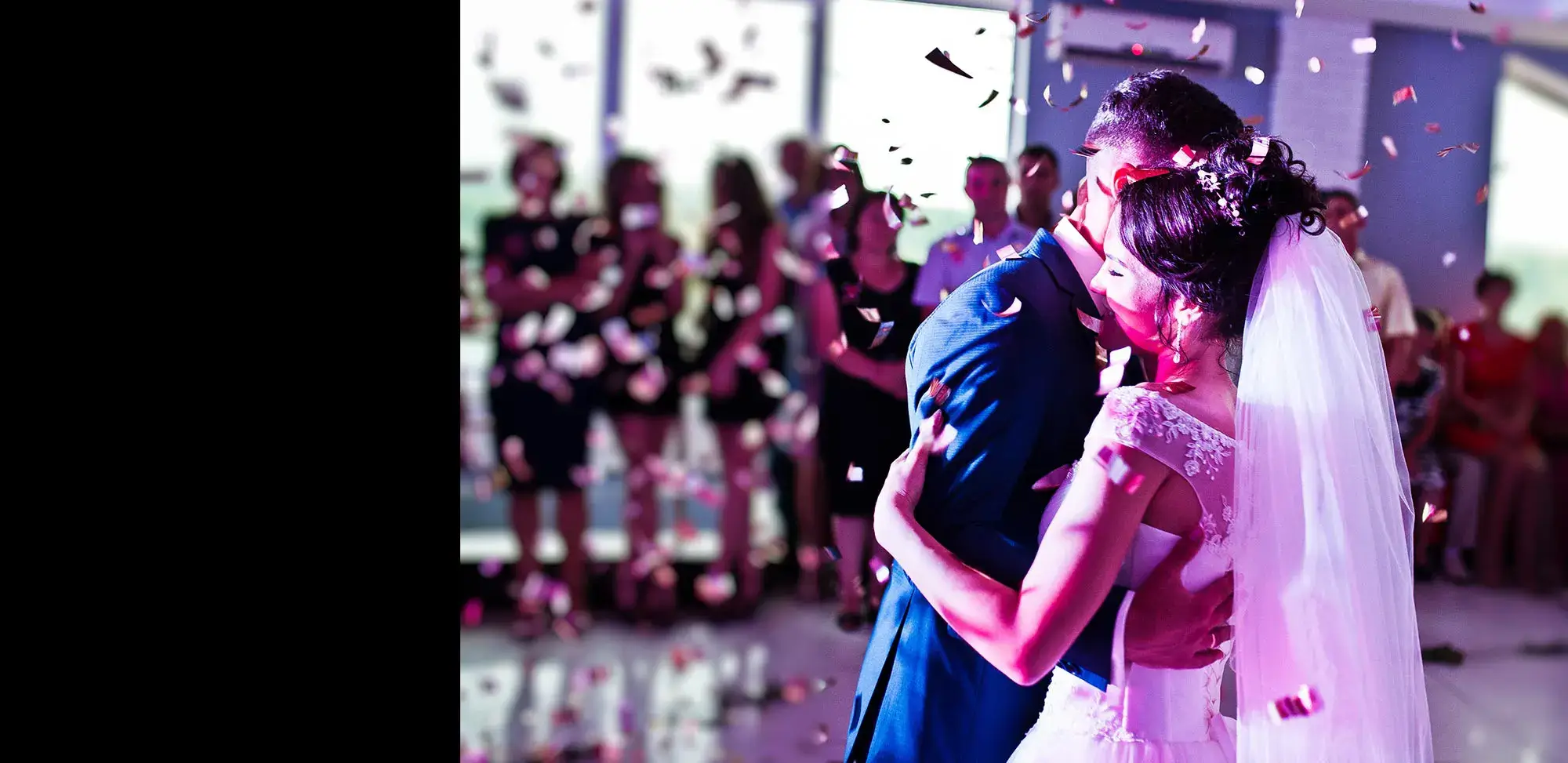 A bride and groom sharing a romantic kiss amidst a shower of confetti at their Pennsylvania wedding.