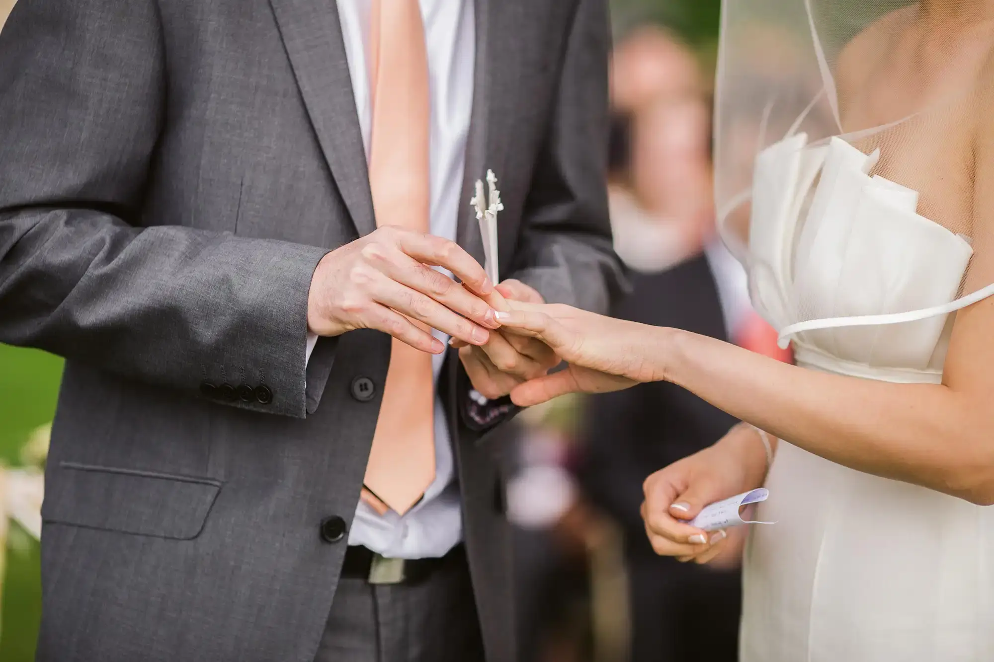 A bride and groom sharing a heartfelt moment as they exchange their wedding rings, accompanied by the melodic tunes curated by skilled Pennsylvania wedding DJs.