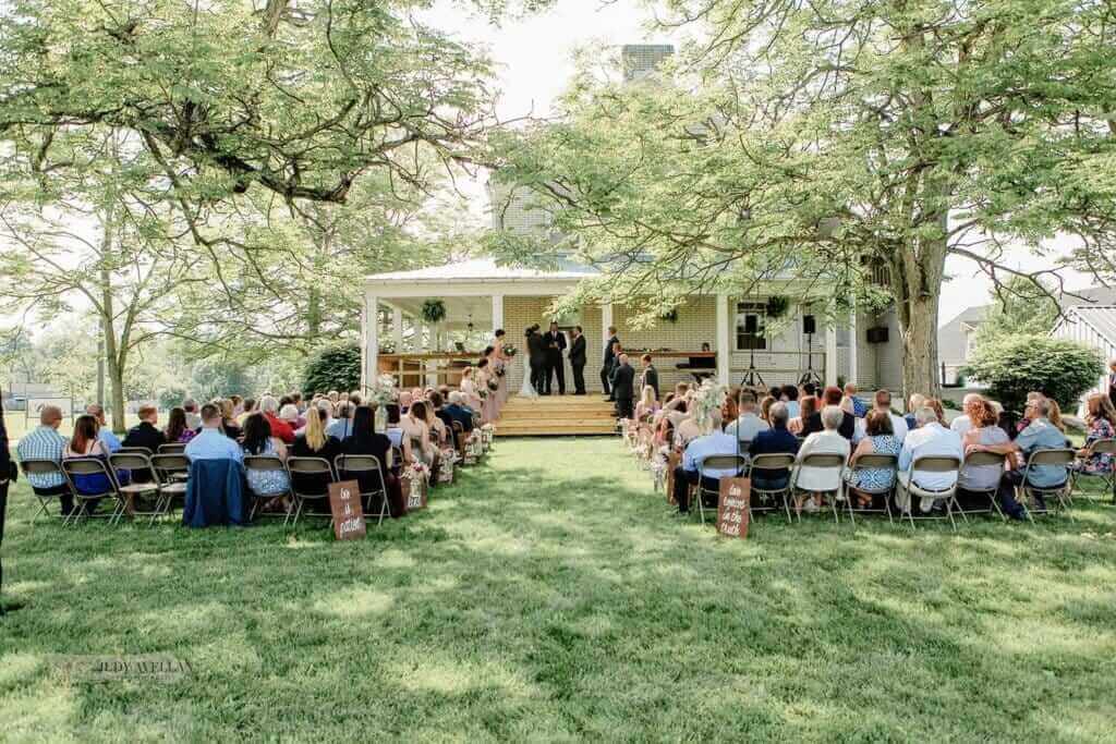 Bride and Groom exchanging vows on the porch Wilson's Bittersweet Barn 