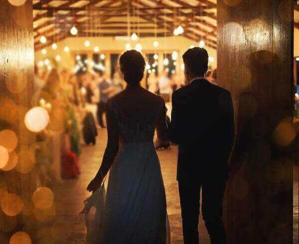 A bride and groom walking down the aisle at a wedding.